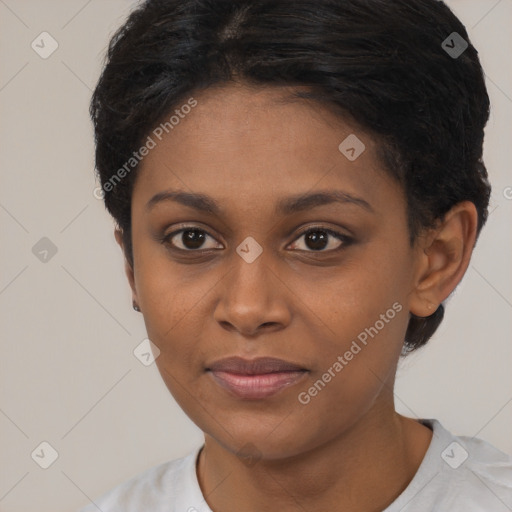 Joyful black young-adult female with short  brown hair and brown eyes