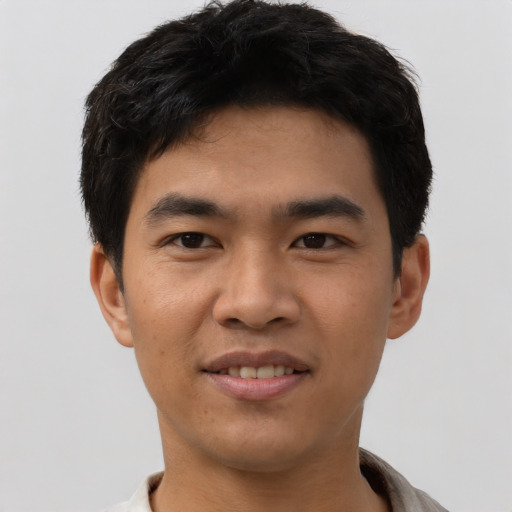 Joyful asian young-adult male with short  black hair and brown eyes