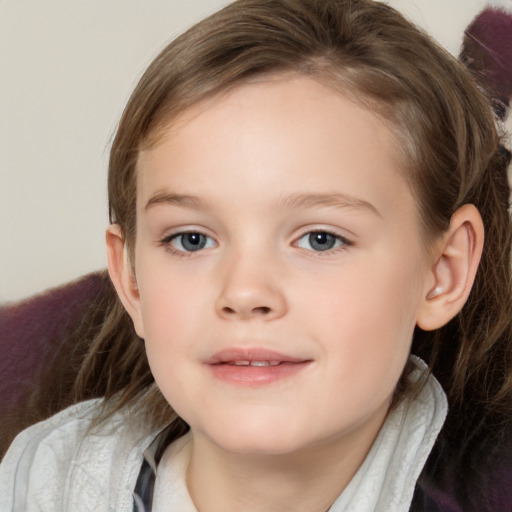 Joyful white child female with medium  brown hair and grey eyes