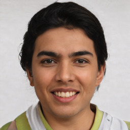 Joyful latino young-adult male with short  black hair and brown eyes