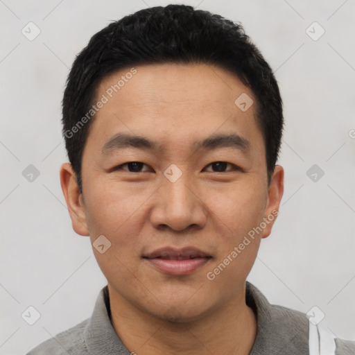 Joyful asian young-adult male with short  black hair and brown eyes