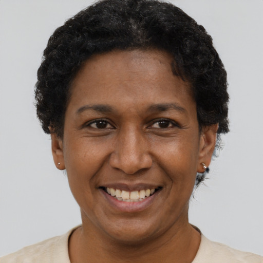 Joyful latino young-adult female with short  black hair and brown eyes