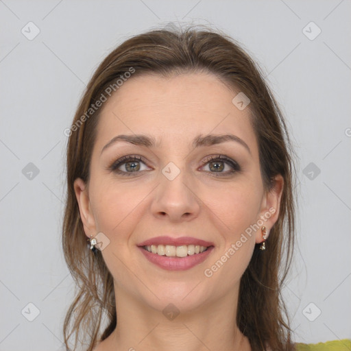 Joyful white young-adult female with medium  brown hair and grey eyes