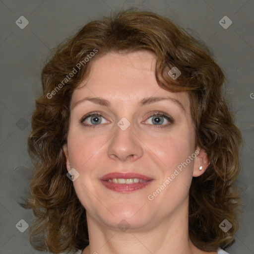 Joyful white adult female with medium  brown hair and blue eyes