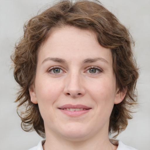 Joyful white young-adult female with medium  brown hair and green eyes