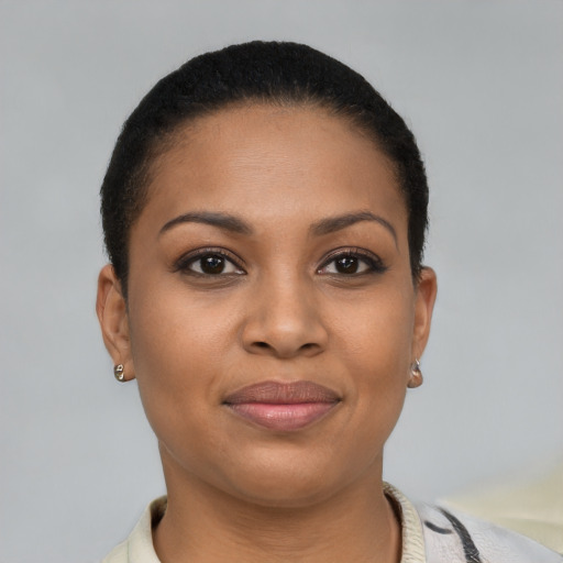 Joyful latino young-adult female with short  brown hair and brown eyes