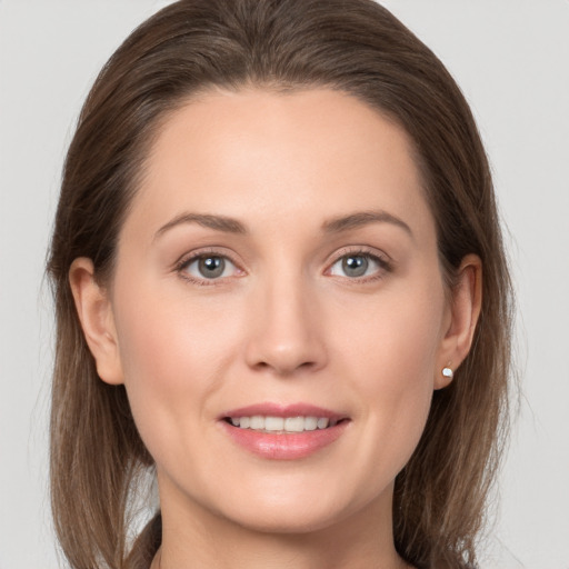 Joyful white young-adult female with long  brown hair and grey eyes