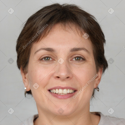 Joyful white adult female with medium  brown hair and grey eyes