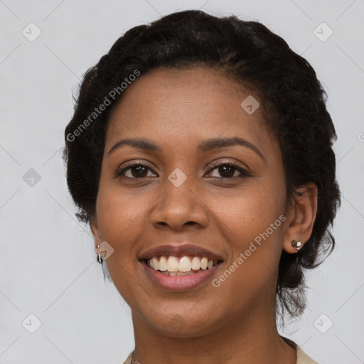 Joyful black young-adult female with short  black hair and brown eyes