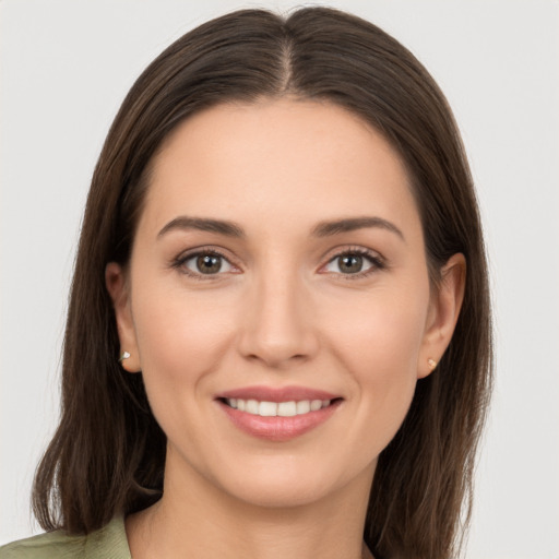 Joyful white young-adult female with long  brown hair and brown eyes