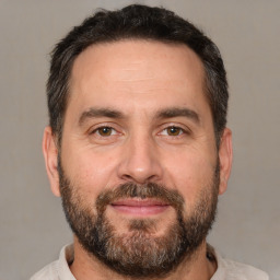 Joyful white adult male with short  brown hair and brown eyes