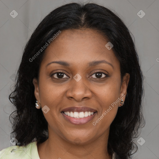 Joyful black young-adult female with long  brown hair and brown eyes