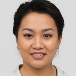 Joyful asian young-adult female with short  brown hair and brown eyes