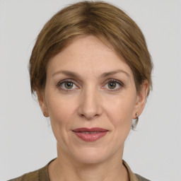 Joyful white adult female with medium  brown hair and grey eyes