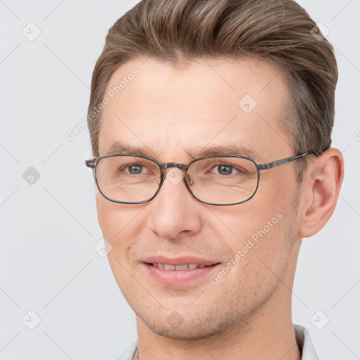 Joyful white adult male with short  brown hair and brown eyes