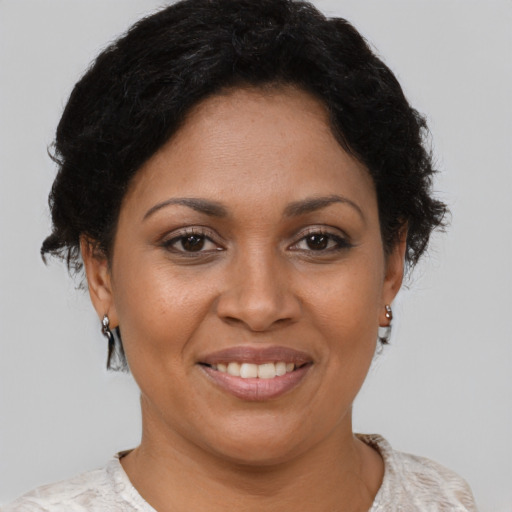 Joyful latino adult female with short  brown hair and brown eyes
