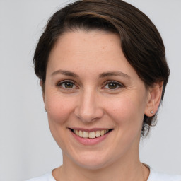 Joyful white young-adult female with medium  brown hair and grey eyes