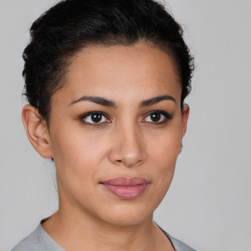 Joyful latino young-adult female with short  brown hair and brown eyes