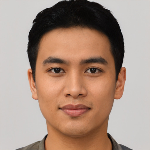 Joyful asian young-adult male with short  black hair and brown eyes