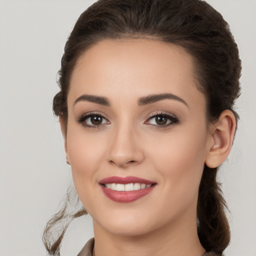 Joyful white young-adult female with long  brown hair and brown eyes