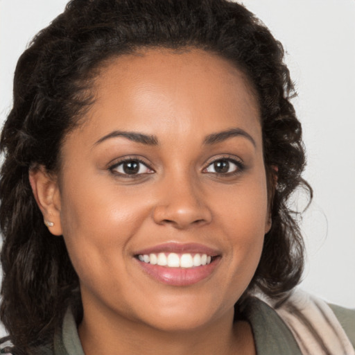 Joyful latino young-adult female with long  brown hair and brown eyes