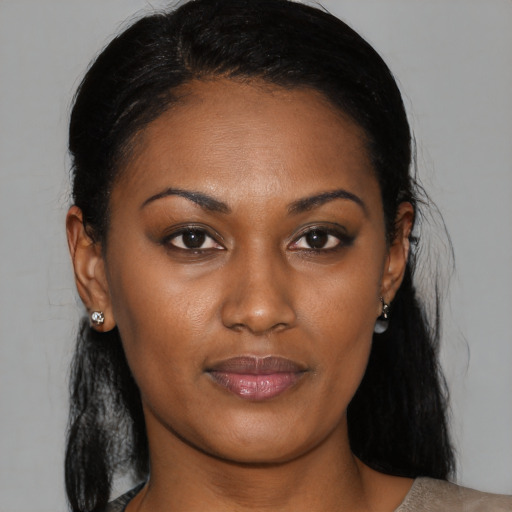 Joyful black young-adult female with medium  black hair and brown eyes