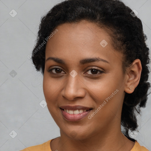 Joyful black young-adult female with long  black hair and brown eyes