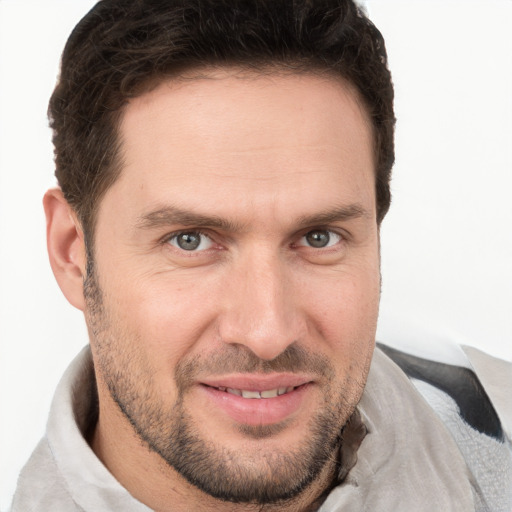 Joyful white adult male with short  brown hair and brown eyes