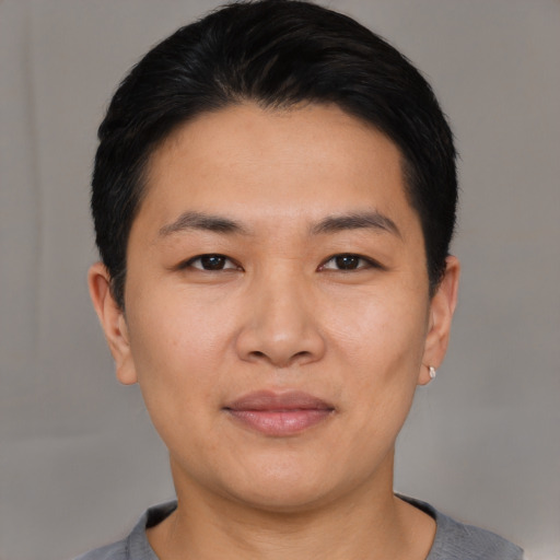 Joyful asian young-adult male with short  black hair and brown eyes