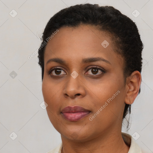 Joyful black young-adult female with short  brown hair and brown eyes