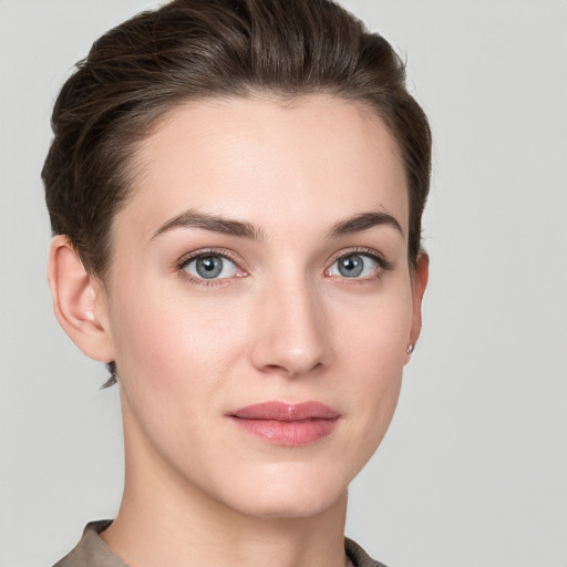 Joyful white young-adult female with short  brown hair and grey eyes