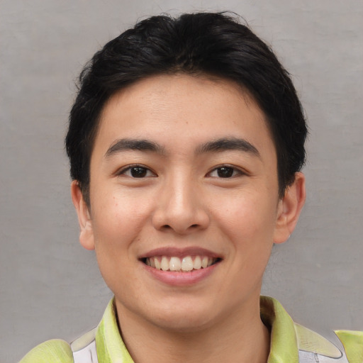 Joyful asian young-adult male with short  brown hair and brown eyes