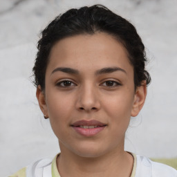 Joyful latino young-adult female with short  brown hair and brown eyes