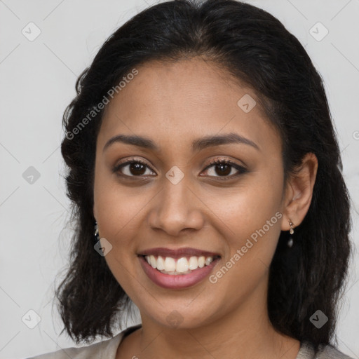 Joyful latino young-adult female with long  brown hair and brown eyes