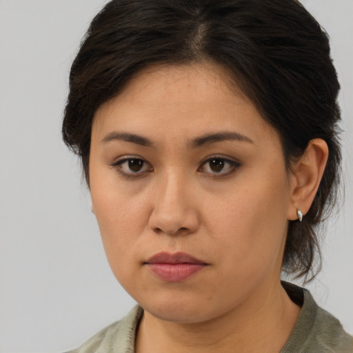 Joyful asian young-adult female with medium  brown hair and brown eyes