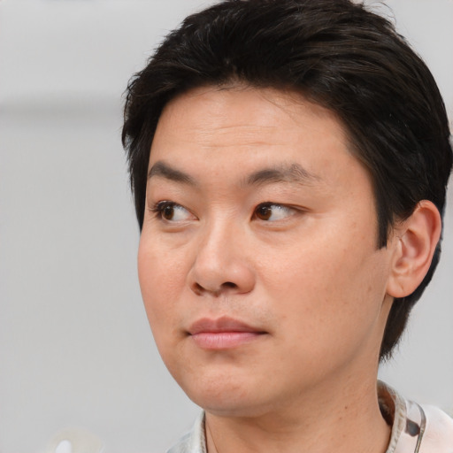 Neutral asian young-adult male with short  brown hair and brown eyes