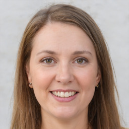 Joyful white young-adult female with long  brown hair and grey eyes