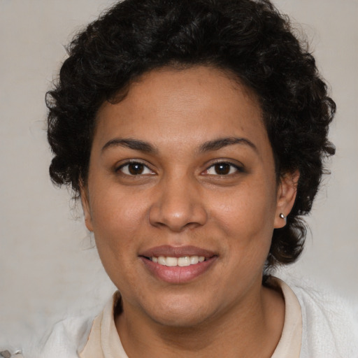 Joyful latino young-adult female with medium  brown hair and brown eyes