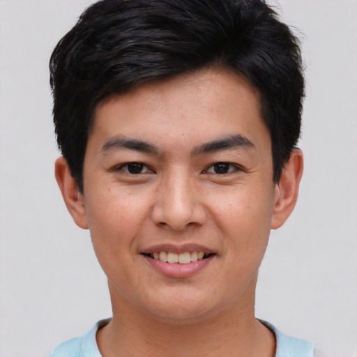 Joyful asian young-adult male with short  brown hair and brown eyes