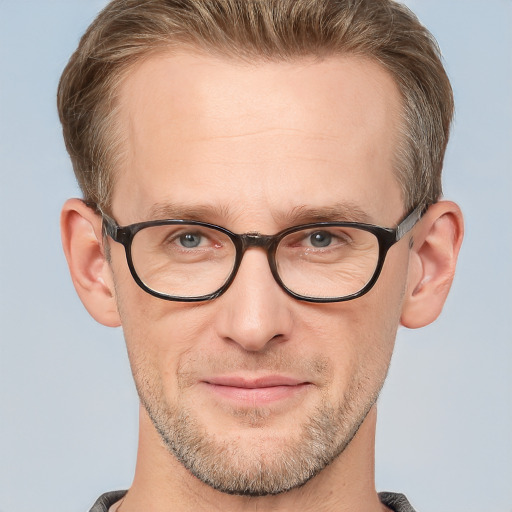 Joyful white adult male with short  brown hair and grey eyes