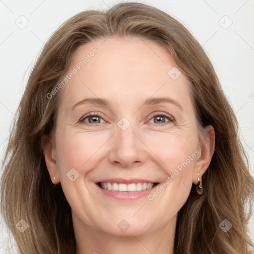 Joyful white adult female with long  brown hair and grey eyes