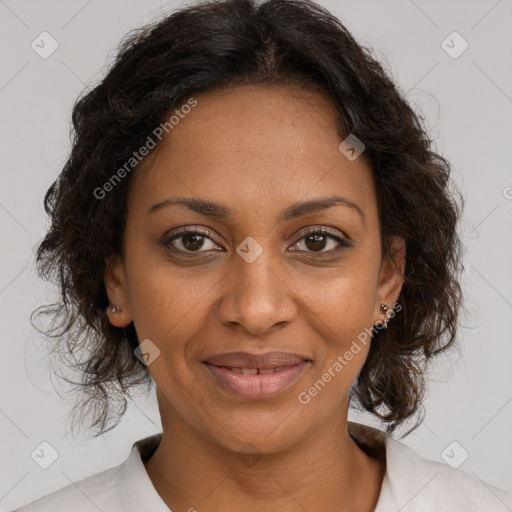 Joyful black adult female with medium  brown hair and brown eyes