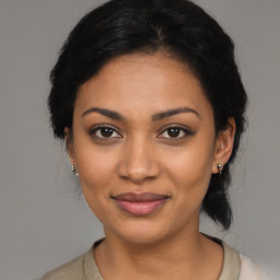 Joyful latino young-adult female with medium  black hair and brown eyes