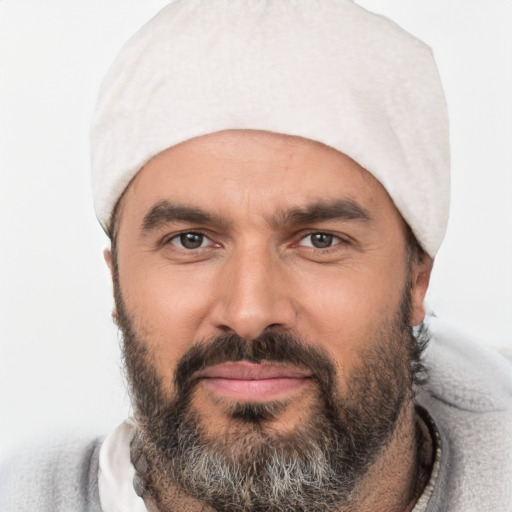 Joyful white adult male with short  black hair and brown eyes