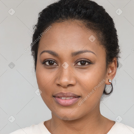 Joyful black young-adult female with short  brown hair and brown eyes