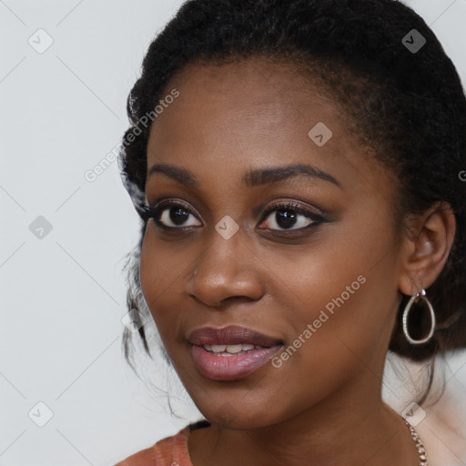 Joyful black young-adult female with long  brown hair and brown eyes