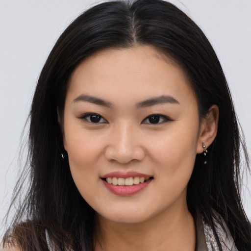 Joyful asian young-adult female with long  brown hair and brown eyes