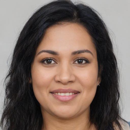 Joyful latino young-adult female with long  black hair and brown eyes