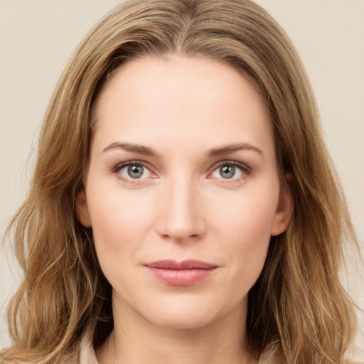 Joyful white young-adult female with long  brown hair and green eyes