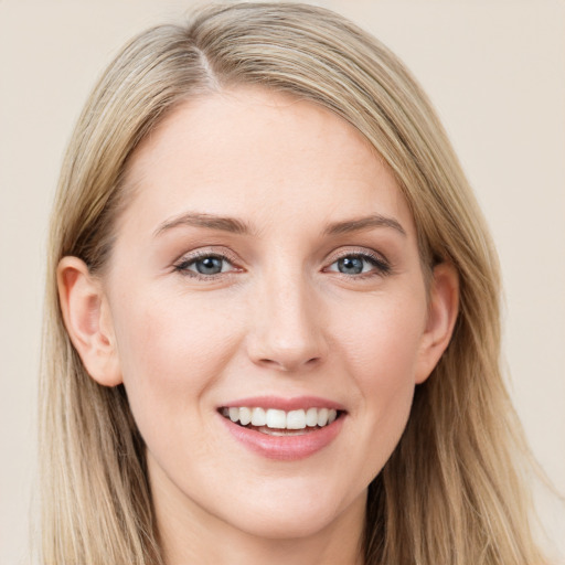 Joyful white young-adult female with long  brown hair and blue eyes